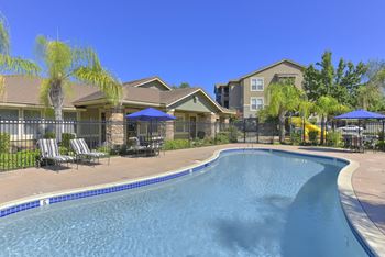 Swimming pool with fenced deck and residential buildings